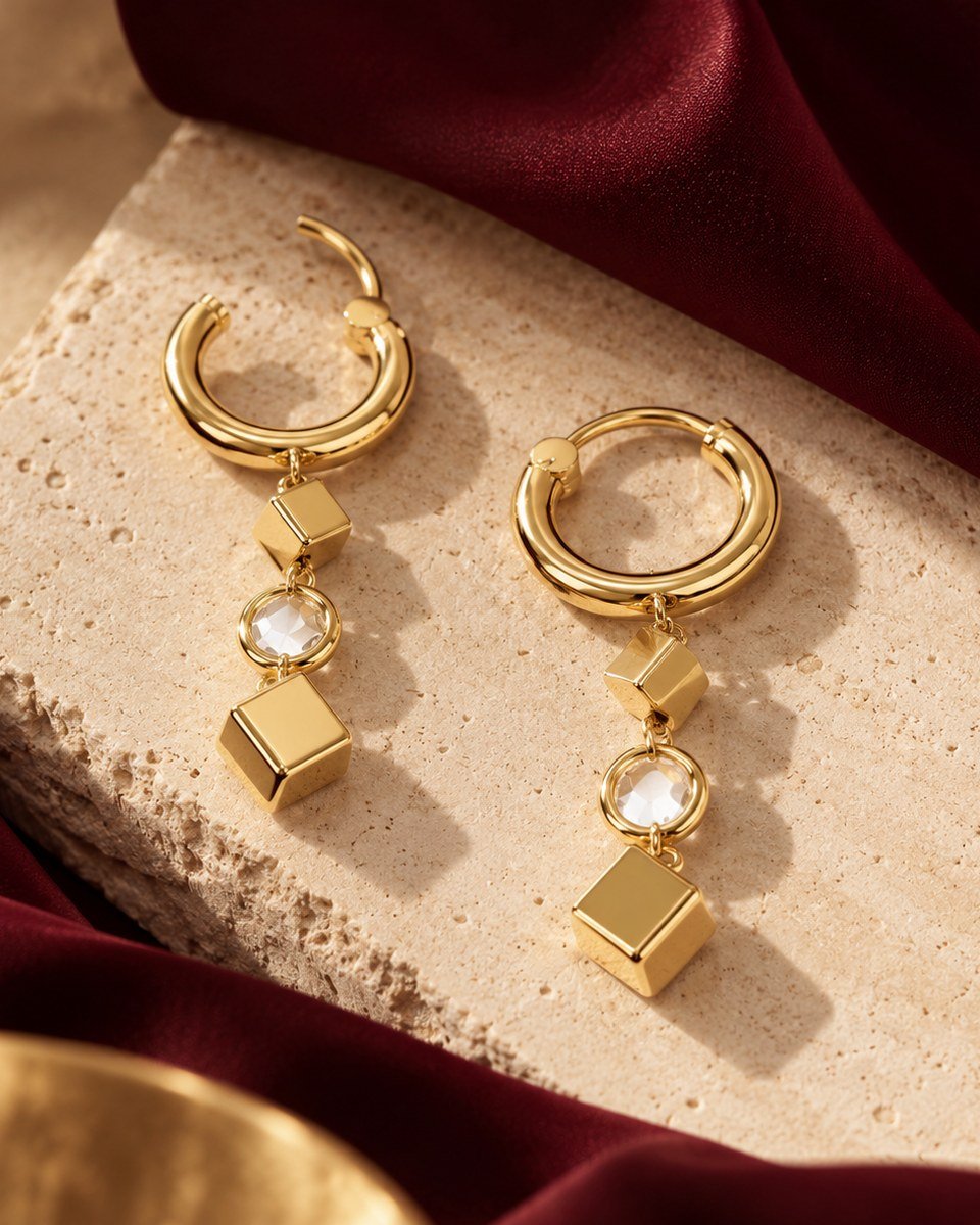 Prism Drop huggie earrings in gold, one open and one clicked shut